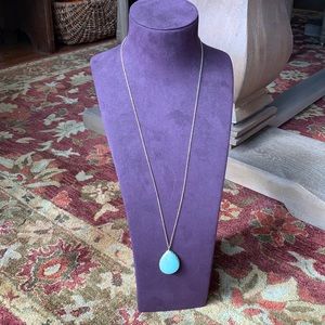 Costume gold colored 32” chain with turquoise colored pendant